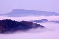 Cold misty foggy morning with twilight sunrise in a fall valley of Bohemian Switzerland park. National park Ceske Svycarsko, beaut Royalty Free Stock Photo