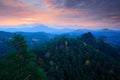 Cold misty morning sunrise in a fall valley of Bohemian Switzerland park. Hill with view hut on hill increased from magical