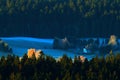 Cold morning in Sumava National park, hills and villages in the fog and rime, misty view on czech landscape, blue winter scene, Tr