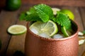 Cold Moscow Mule cocktail in copper mug on the rustic background Royalty Free Stock Photo