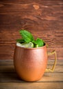 Cold Moscow Mule cocktail in copper mug on the rustic background Royalty Free Stock Photo