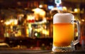 Cold mug of beer in a bar on wooden table Royalty Free Stock Photo