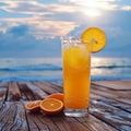 Cold orange juice with ice on a wooden balcony by sea Royalty Free Stock Photo