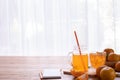 Cold Orange juice and Sliced orange on wood table