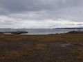 Cold and overcast day in northern norway with snowy mountains and calm seas Royalty Free Stock Photo