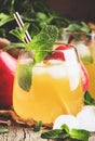 Cold pear juice, iced summer non-alcoholic cocktail with mint, old wooden table background, selective focus Royalty Free Stock Photo