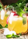 Cold pear juice, iced summer non-alcoholic cocktail with mint, old wooden table background, selective focus Royalty Free Stock Photo