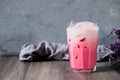 cold pink milk cold drink in clear glass on gray background. Thai milk Royalty Free Stock Photo