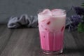 cold pink milk cold drink in clear glass on gray background. Thai milk Royalty Free Stock Photo