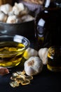 Cold pressed garlic oil in bowl with  garlic oil capsule on dark background. Royalty Free Stock Photo
