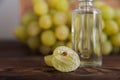 Cold pressed grape oil. Organic bio care products with natural ingredients. Close-up grapes and copy space. Halved grapes and grap