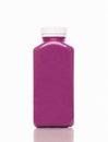 Cold-pressed violet blueberry and cranberry juice for detoxification on a white background. Royalty Free Stock Photo
