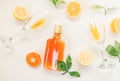 Cold refreshing alcohol drink bottle with two glasses , orange and lemon slices decoration on a white background .Top view, flat l Royalty Free Stock Photo