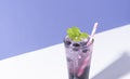 Cold And Refreshing  Blueberry Punch Cocktail With Mint On Purple Background. Summer Drink