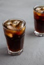 Cold Refreshing Dark Cola with Ice Cubes on a gray background, side view. Close-up Royalty Free Stock Photo