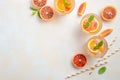 Cold refreshing drink with blood orange slices in a glass on a white concrete background. Royalty Free Stock Photo