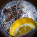 Cold refreshing drink in a glass with sparkling water, ice and lemon. Royalty Free Stock Photo