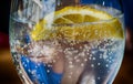 Cold refreshing drink in a glass with sparkling water, ice and lemon. Royalty Free Stock Photo