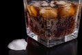 A cold refreshing drink with ice in a glass. Ice cubes and a sweet cold drink in a glass dish Royalty Free Stock Photo