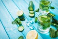 Cold and refreshing infused detox water with lime, mint and cucumber in a glass on wood background Royalty Free Stock Photo
