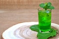 Cold and refreshing lime and mint green water in a glass on wood Royalty Free Stock Photo