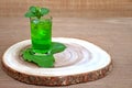 Cold and refreshing lime and mint green water in a glass on wood Royalty Free Stock Photo