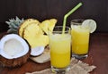 Cold refreshing pineapple coconut mocktail drink with lime in glasses Royalty Free Stock Photo