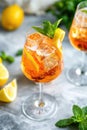 Cold refreshing summer drink with ice, lemon, and mint on marble table Royalty Free Stock Photo