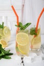 Cold refreshing summer drink with lemon and mint on wooden background Royalty Free Stock Photo