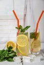 Cold refreshing summer drink with lemon and mint on wooden background Royalty Free Stock Photo