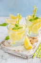 Cold refreshing summer drink with lemon and mint on wooden background. Royalty Free Stock Photo