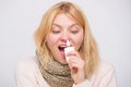 For cold relief. Unhealthy girl with runny nose using nasal spray. Sick woman spraying medication into nose. Cute woman Royalty Free Stock Photo