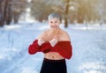 Cold resistance training and tempering. Positive senior man taking off his sweater at snowy winter park. Healthy living Royalty Free Stock Photo