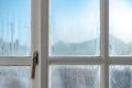 Cold room interior looking out onto water condensation on a bedroom window. Royalty Free Stock Photo