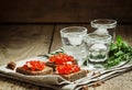 Cold Russian vodka with ice and small snacks sandwiches with but Royalty Free Stock Photo