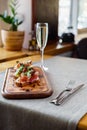 Platter: cold salmon bruschetta and greens with a glass of champagne Royalty Free Stock Photo