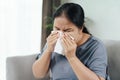 Cold sick woman got nose allergy cough or sneeze with tissue paper sitting on the sofa. Healthcare and medical concept Royalty Free Stock Photo
