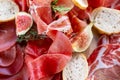 Light Italian snacks. A buffet table at a dinner party. Food tray with delicious salami, pieces of sliced ham, sausage Royalty Free Stock Photo