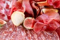 Light Italian snacks. A buffet table at a dinner party. Food tray with delicious salami, pieces of sliced ham, sausage Royalty Free Stock Photo