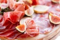 Light Italian snacks. A buffet table at a dinner party. Food tray with delicious salami, pieces of sliced ham, sausage Royalty Free Stock Photo