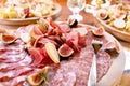 Light Italian snacks. A buffet table at a dinner party. Food tray with delicious salami, pieces of sliced ham, sausage Royalty Free Stock Photo