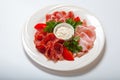 Cold smoked meat plate with prosciutto, salami, bacon, ham and sauce on a white plate. Royalty Free Stock Photo