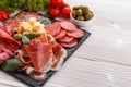 Cold smoked meat plate on a rustic wooden background Royalty Free Stock Photo