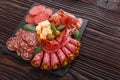 Cold smoked meat plate on a rustic wooden background Royalty Free Stock Photo