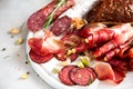 Cold smoked meat plate. Traditional italian antipasto, cutting board with salami, prosciutto, ham, pork chops, olives on Royalty Free Stock Photo