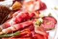 Cold smoked meat plate. Traditional italian antipasto, cutting board with salami, prosciutto, ham, pork chops, olives on Royalty Free Stock Photo