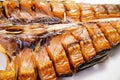 Cold-smoked silver carp fish on a white background. salty snacks to beer.