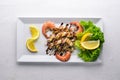 Cold snacks. Seafood, shrimp, mussels, squid, octopus. On a wooden background. Royalty Free Stock Photo