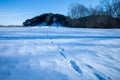 Cold snowy winter in Vallensbaek Denmark - footsteps in snow towards a hill