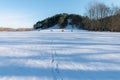 Cold snowy winter in Vallensbaek Denmark - footsteps in snow towards a hill